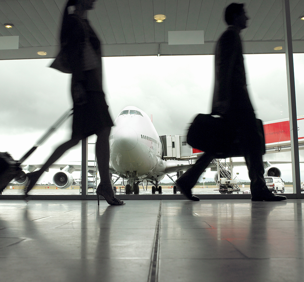 People walking through airport, silhouette (focus on aeroplane)
