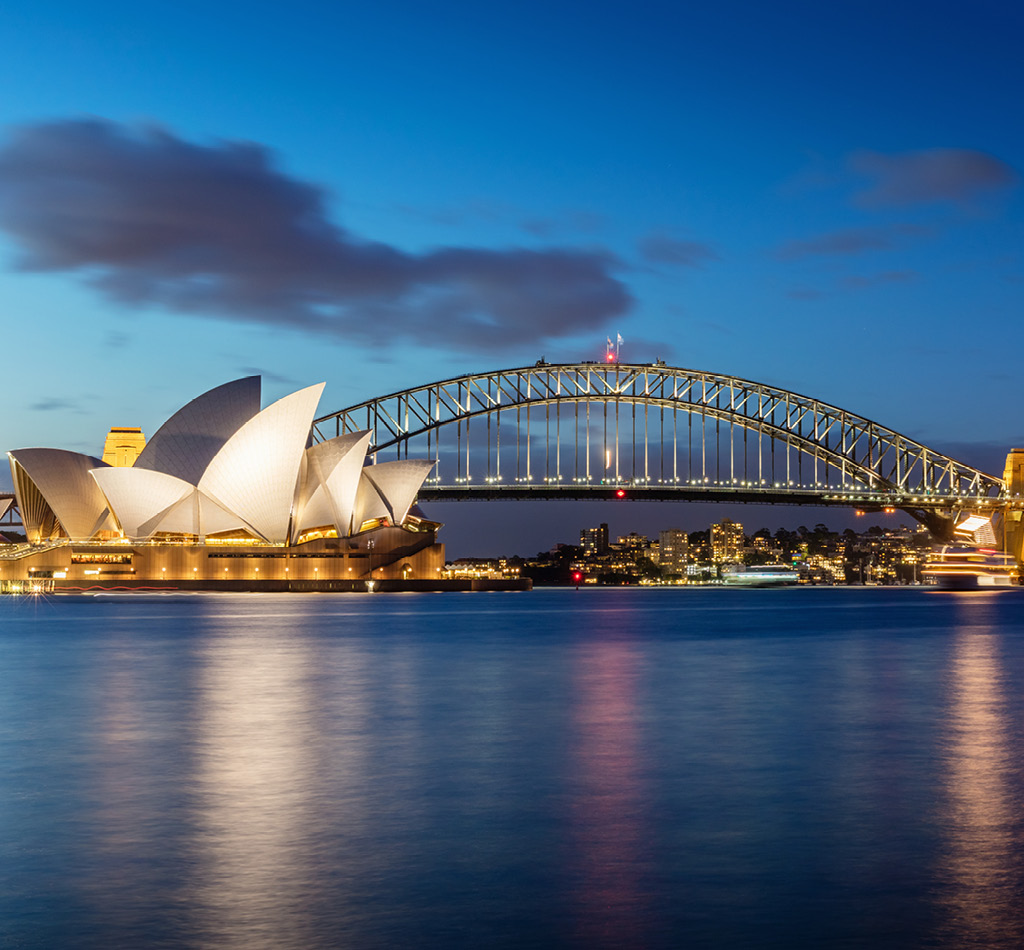 Sydney skyline at twilight, with the Sydney Opera House and Harbour Bridge.