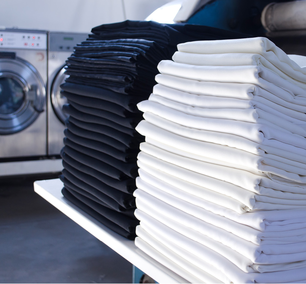 Stack of folded cloths in an industrial laundry.