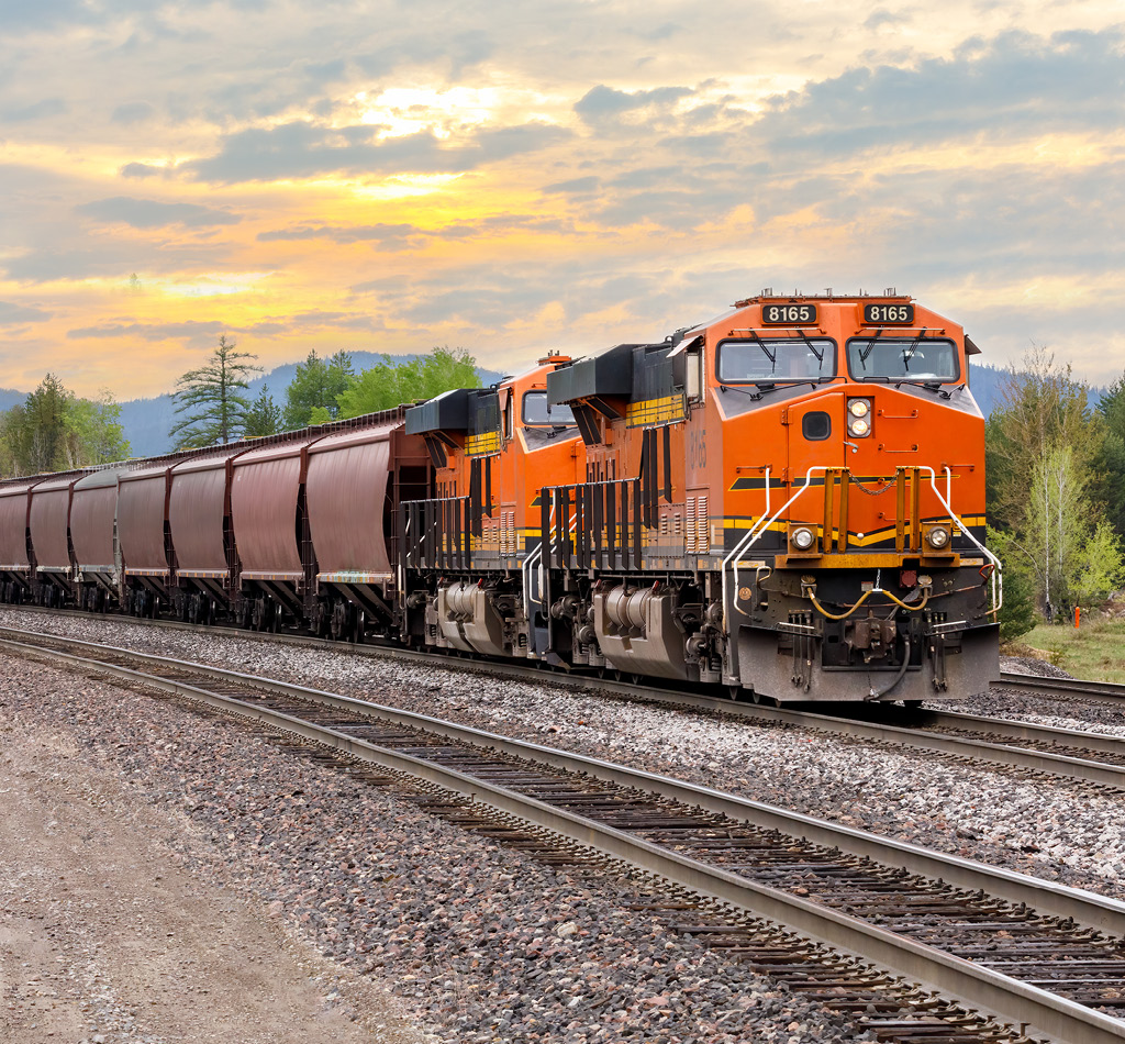 Freight train with a colorful sunset in the background in Montana.