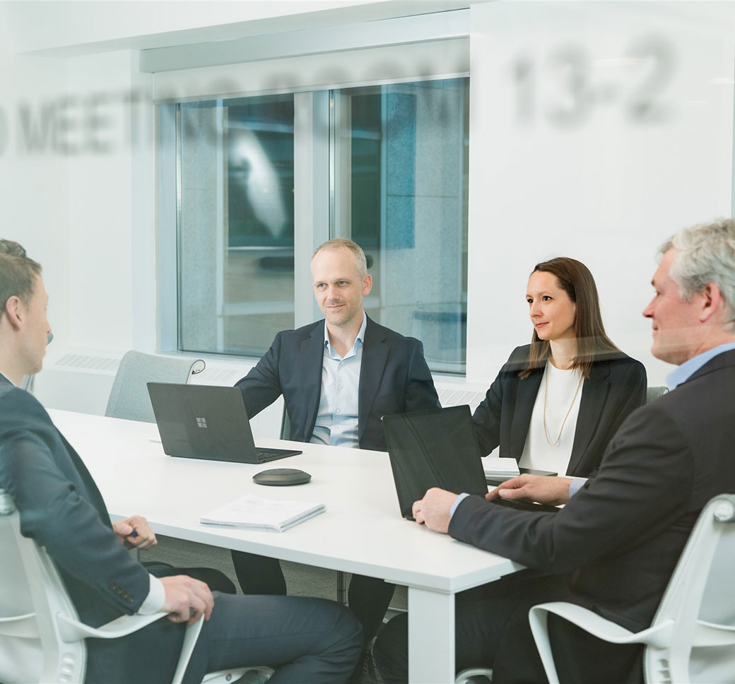 http://Image%20of%20people%20sitting%20and%20talking%20at%20a%20meeting%20table